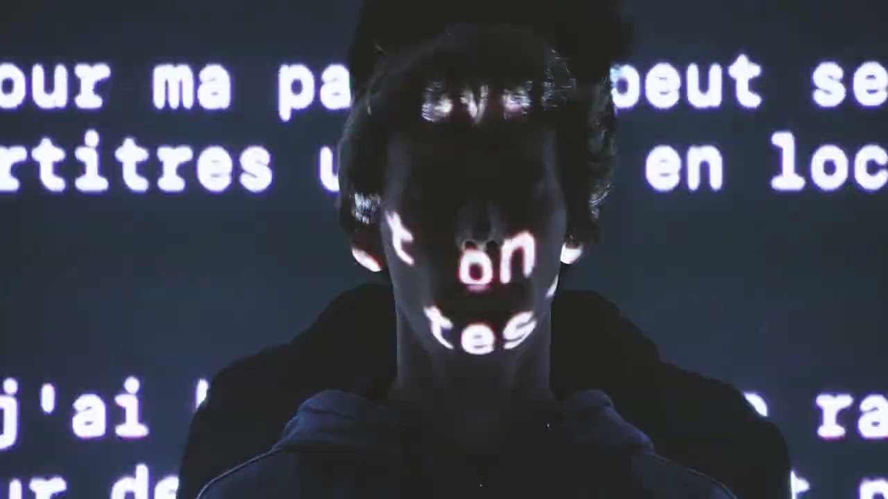 Man in front of projection of computer code.